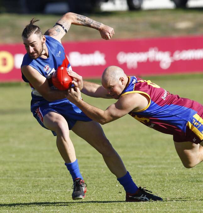 CHANCE: GGGM's Mitch Carroll (right) tackles Turvey Park's Josh Ashcroft. Carroll may return from injury on Sunday.