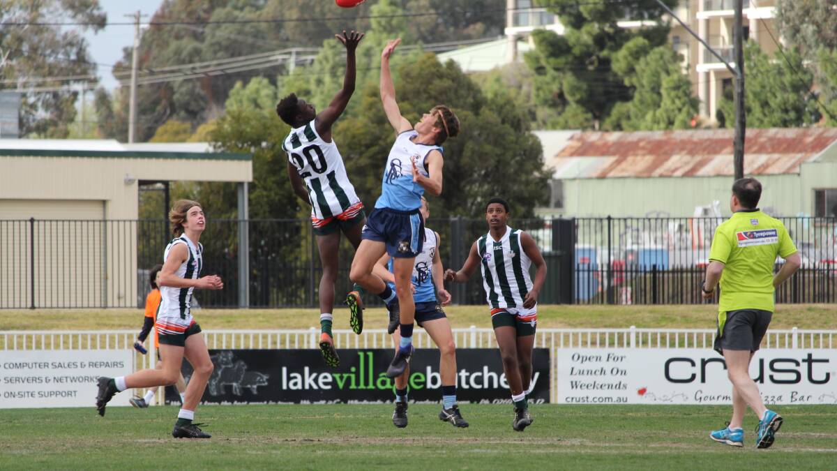 BIG LEAP: The Riverina Anglican College's Godfrey Okerenyang flies high in the ruck against St Francis Leeton in the under 15 Southern NSW finals at Robertson Oval on Wednesday. Picture: Sarah Braybon