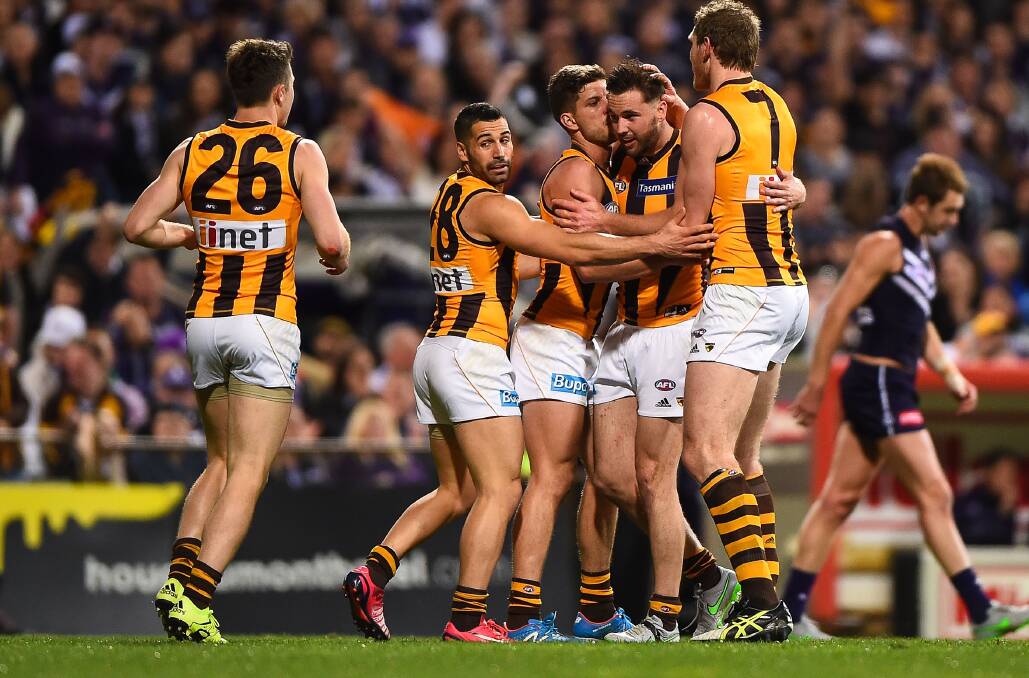 MAN OF THE MOMENT: Matt Suckling (second from right) is flanked by Hawthorn teammates after kicking a big goal against Fremantle on Friday.