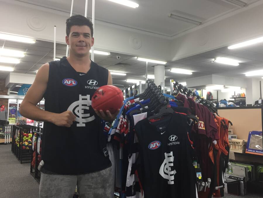 NEW COLOURS: Matt Kennedy gets used to his new Carlton colours at Sportsmans Warehouse in Wagga on Thursday. Picture: Matt Malone