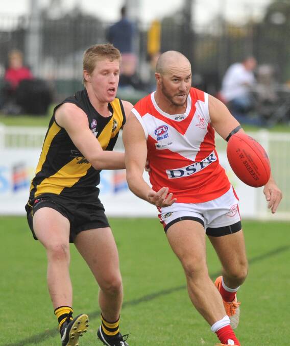 MILESTONE MAN: Collingullie-Glenfield Park's Brad Aiken leads up at the ball despite pressure from Wagga Tigers' Sam Lucas at Robertson Oval on Saturday. Picture: Laura Hardwick