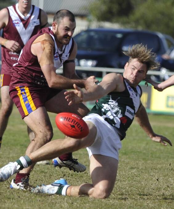 NABBED: Coolamon's Daniel Johnson tries to get boot to ball as Ganmain-Grong Grong-Matong's Lachlan Steward grabs hold in Sunday's Riverina League clash at Ganmain Sportsground. Picture: Les Smith