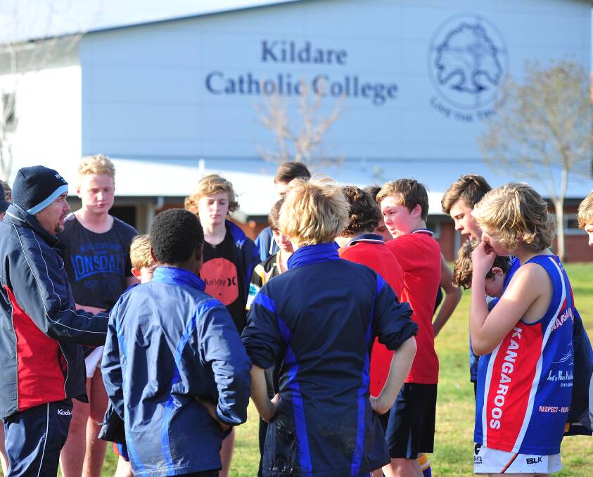 PREPARATION: Kildare Catholic College under 13 coach Matt Conn speaks to his team at their final training session on Monday. Pictures: Kieren L Tilly