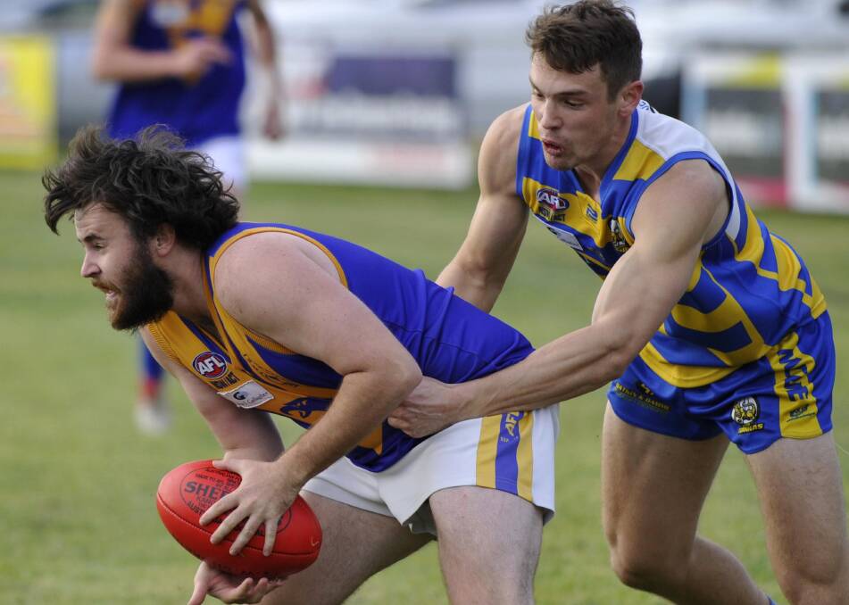 GOT HIM: Narrandera's Shaun Gehringer gets wrapped up by Mangoplah-Cookardinia United-Eastlakes' Tom Keogh on Saturday. Picture: Les Smith