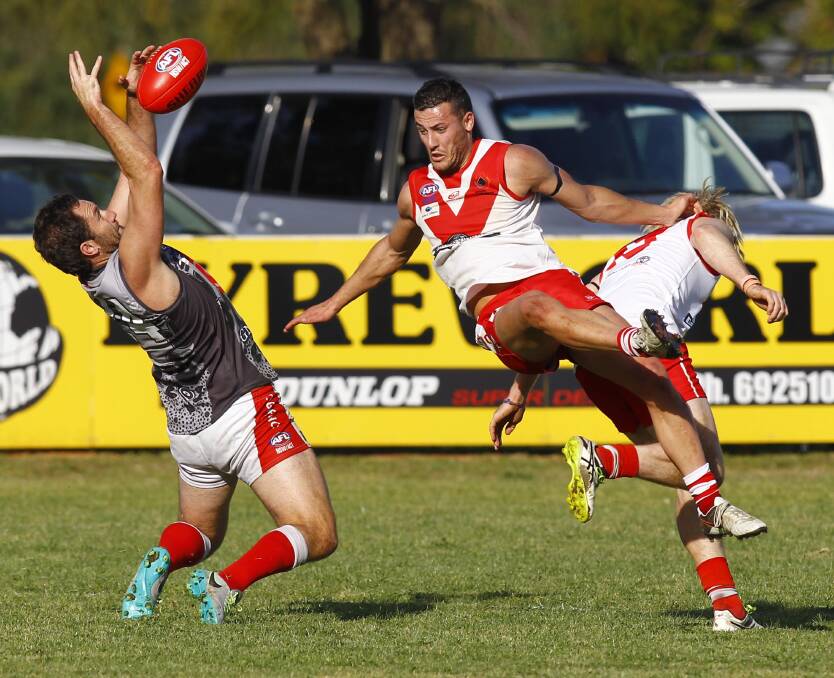 ON SONG: Collingullie-GP's Marc Geppert marks against Griffith's Jordan Iudica and Ash Verhagen at Crossroads Oval on Saturday. Picture: Les Smith