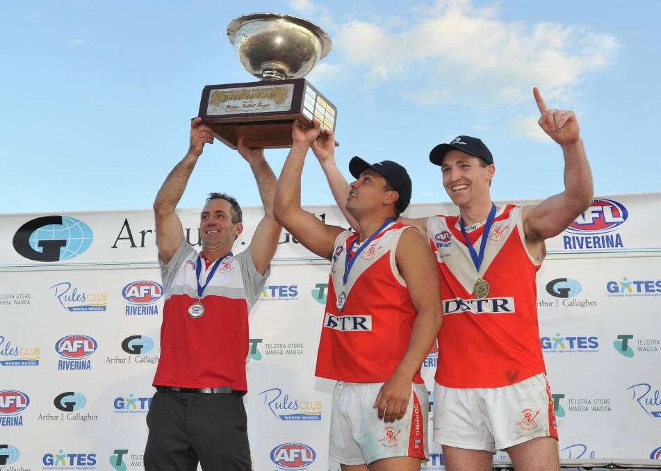 NOT LONG AGO: Chris Gordon lifts the premiership cup with Brett Lenon (left) and Kal Sykes (right) in September. Picture: Laura Hardwick
