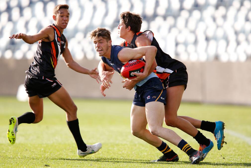 TOP PERFORMER: Jock Cornell gets tackled by Ben Long in the game against Northern Territory in the AFL national under 18 championships at Simonds Stadium last Saturday.