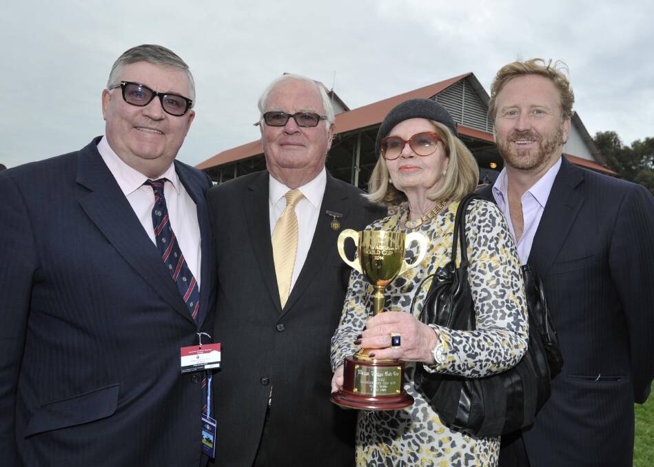 Garry Towzell and wife Marianne, pictured with Richard Pegum (left) and Paul Henry (right) after winning the 2014 Wagga Gold Cup with Trade Commissioner. Picture by Les Smith