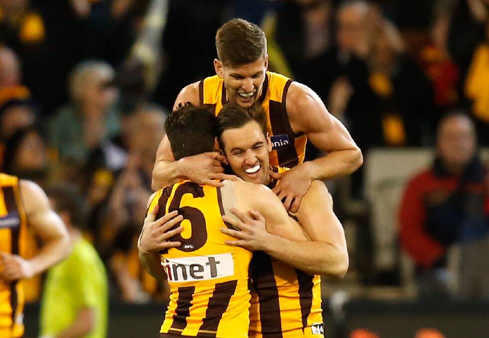 TIGHT UNIT: AFL Riverina products Isaac Smith, Matt Suckling and Luke Breust celebrate a goal in the second semi-final win over Adelaide.