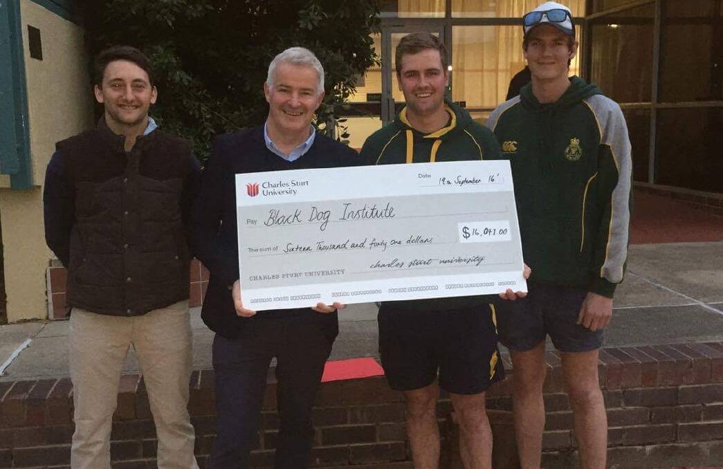 TOP EFFORT: Macky Lawrence, Nicholas Hogan and Hugh Willoughby present a cheque for $16,000 to Black Dog Institute's Mathew Johnstone (second from left). 