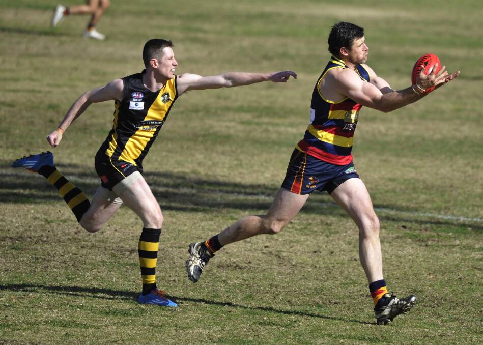 FULL STRETCH: Leeton-Whitton's Neil Irwin takes a mark in front of Wagga Tigers' Xavier Brennan in the qualifying final at Narrandera.