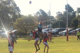 Northern Jets forward Charlie McCormack soars high over Marrar's Connor Willis and Jed Jenkins in the Farrer League game at Ardlethan Sportsground on Saturday. Picture by Matt Malone