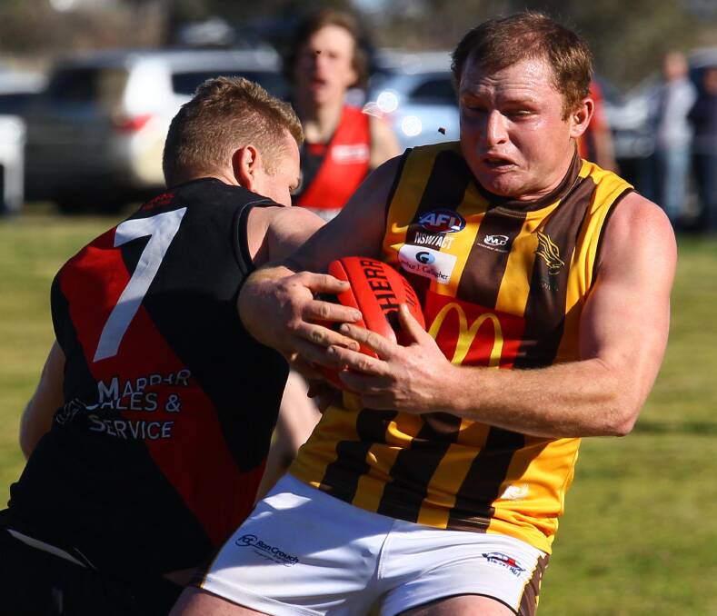 CLASH: Marrar's Geoff Spriggs bumps East Wagga-Kooringal's Joe Scott in the Farrer League clash at Langtry Oval on Saturday. Picture: Les Smith