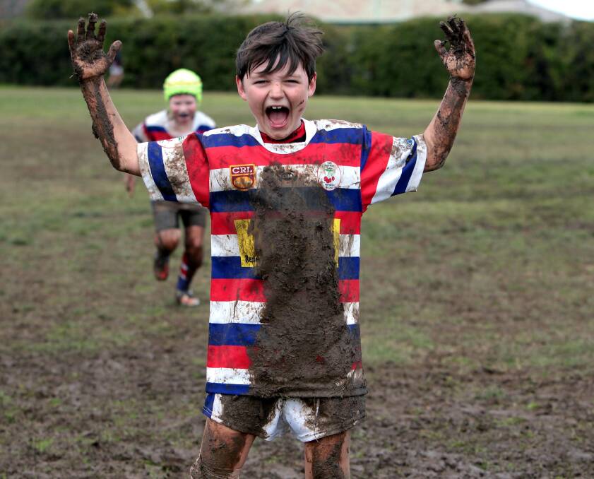 FUN IN THE MUD: Young's Will Bryant shows how muddy the conditions were at Harris Park on Saturday. Picture: Les Smith
