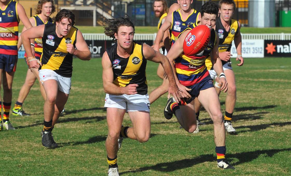 RACE IS ON: Waggs Tigers' Campbell Lovell leads Leeton-Whitton's Luke Potter to the ball at Robertson Oval on Saturday. Picture: Kieren L Tilly
