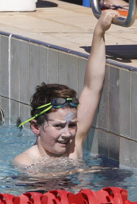 WINNER: 12-year-old Tom Prescott, of Farrer House, earns a spell after winning his 100 metre freestyle event at Wagga High School's swimming carnival on Thursday night. Picture: Les Smith
