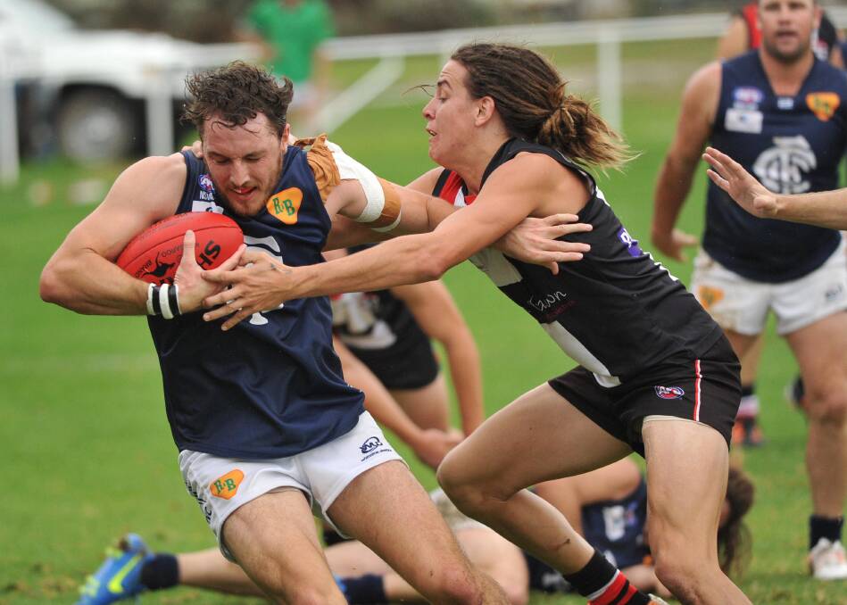 CAUGHT: Coleambally's Adam Norton looks to evade North Wagga's Ben Alexander at McPherson Oval on Saturday. Picture: Laura Hardwick
