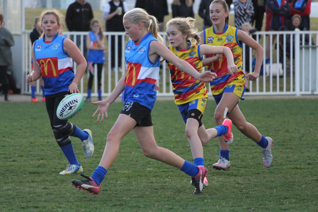 SPECIAL OCCASION: Turvey Park's Sarah Barkla gets boot to ball in night one of the Wagga girls AFL competition at Robertson Oval on Wednesday night. Picture: Sarah Braybon