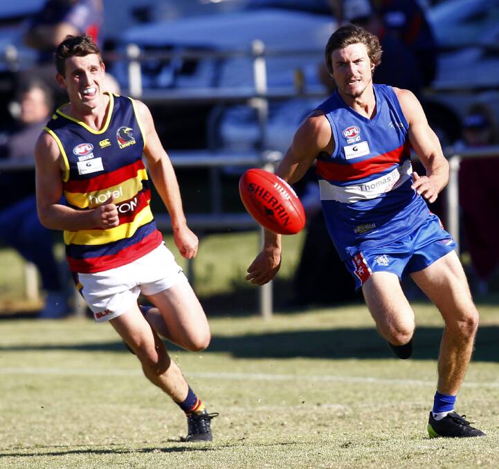 ON THE HUNT: Leeton-Whitton's Tom Meline and Turvey Park's Myles Carroll chase the ball in the game at Maher Oval on Saturday. Picture: Les Smith