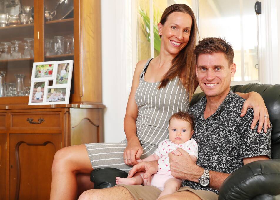 NEW BEGINNING: Wagga triathlete Brad Kahlefeldt at home with wife Radka and 10-week old daughter Ruby this week. Picture: Kieren L Tilly