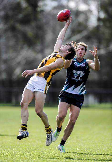 ON THE MOVE: Sean Wilkinson (left) in action for Tuggeranong against Belconnen's Simon Curtis in a 2013 NEAFL game. Picture: The Canberra Times