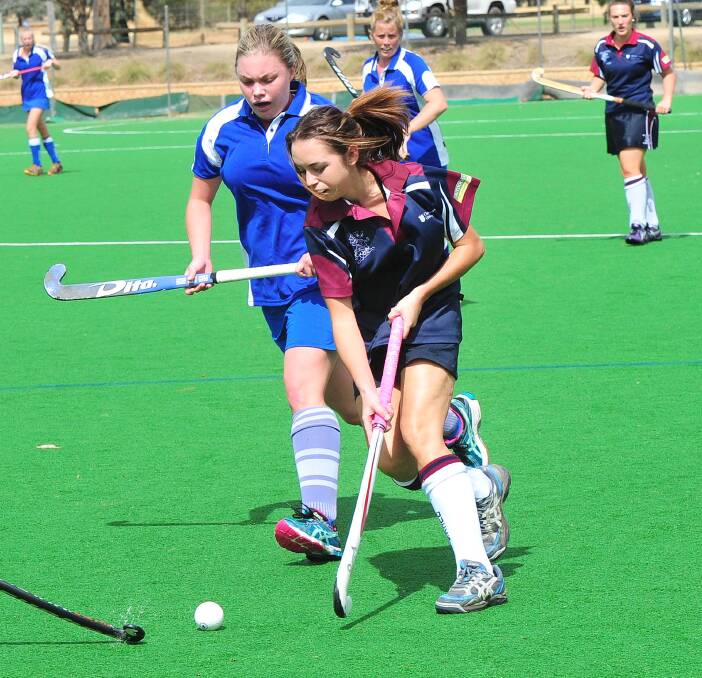 ON THE ATTACK: CSU Navy's Brooke Reeve moves the ball forward despite pressure from Royals White's Courtney McVeigh in the women's division one game on Sunday. Picture: Kieren L Tilly