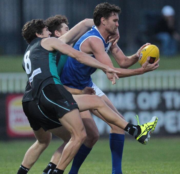 HANDS FULL: Farrer League big man Stephen Conlan grabs the footy as he tries to break free of Black Diamond's Jake Hartikainen at Robertson Oval on Saturday night. Picture: Les Smith