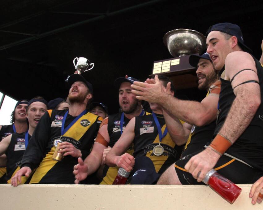 PARTY TIME: Wagga Tigers players get their hands on the premiership trophy for the first time in nine years.