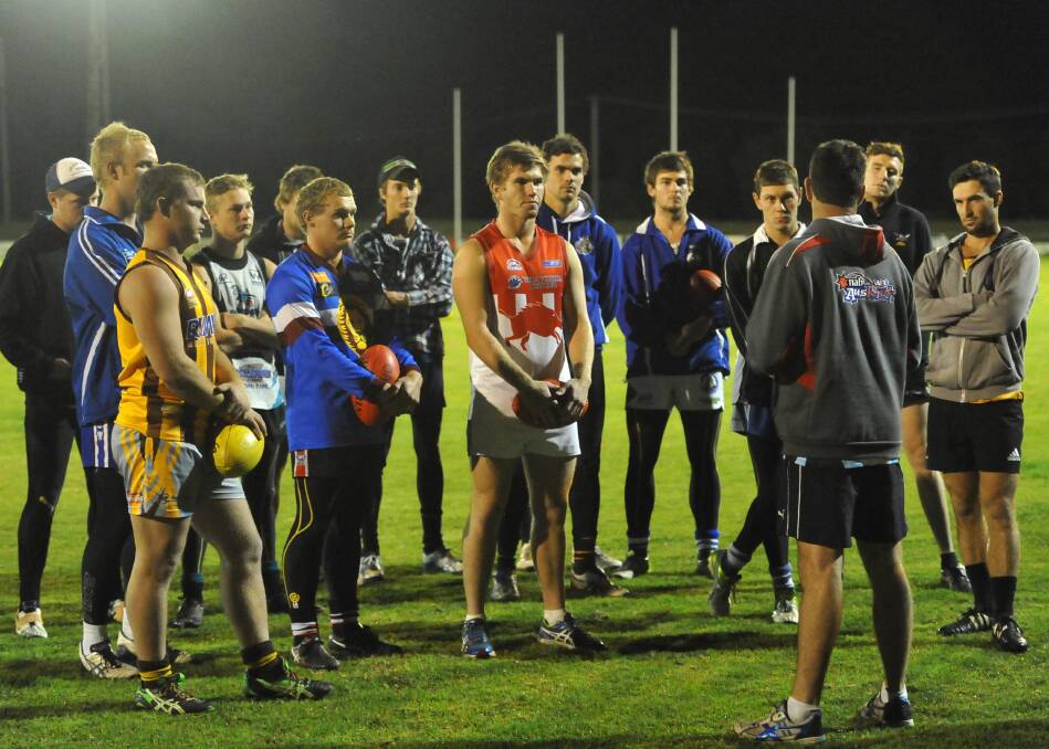 READY TO GO: Farrer League players listen to coach Jason McPherson at training on Wednesday night at Maher Oval. Picture: Laura Hardwick