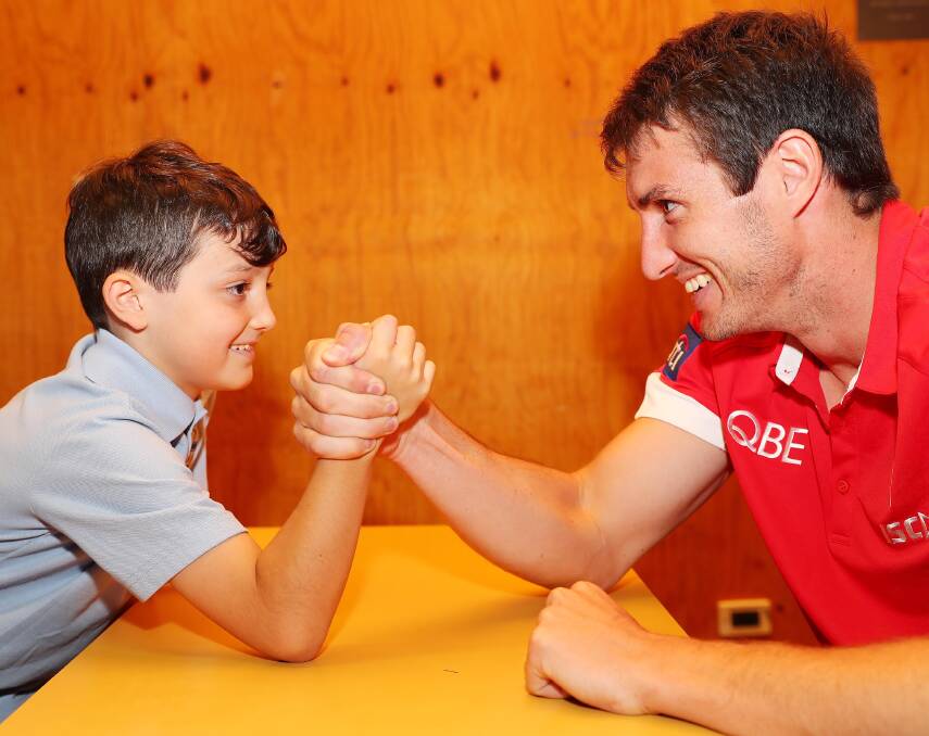 UP FOR THE CHALLENGE: Sydney Swans player Dean Towers takes on Wagga Public School's Loki Carlish, 9, on Tuesday. Picture: Kieren L Tilly