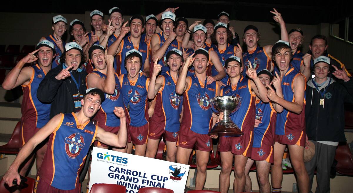 THREE PEAT: Mater Dei Catholic College celebrate an upset victory in the Carroll Cup final at Robertson Oval on Monday night. Picture: Les Smith