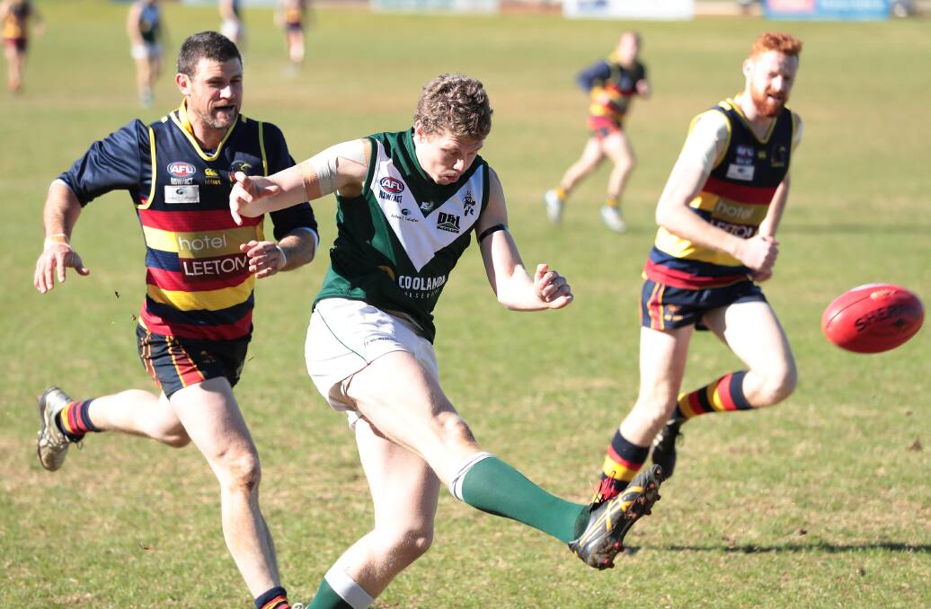 AGILE: Coolamon's Joe Redfern sends the ball forward as Leeton-Whitton's Neil Irwin gives chase at Kindra Park on Sunday. Picture: Kieren L Tilly