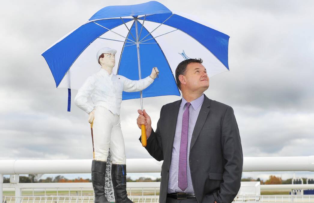 TOUGH CALL: Murrumbidgee Turf Club chief executive Scott Sanbrook inspects the weather at the Kurrajong Waratah Charity race day on Saturday. Picture: Kieren L Tilly