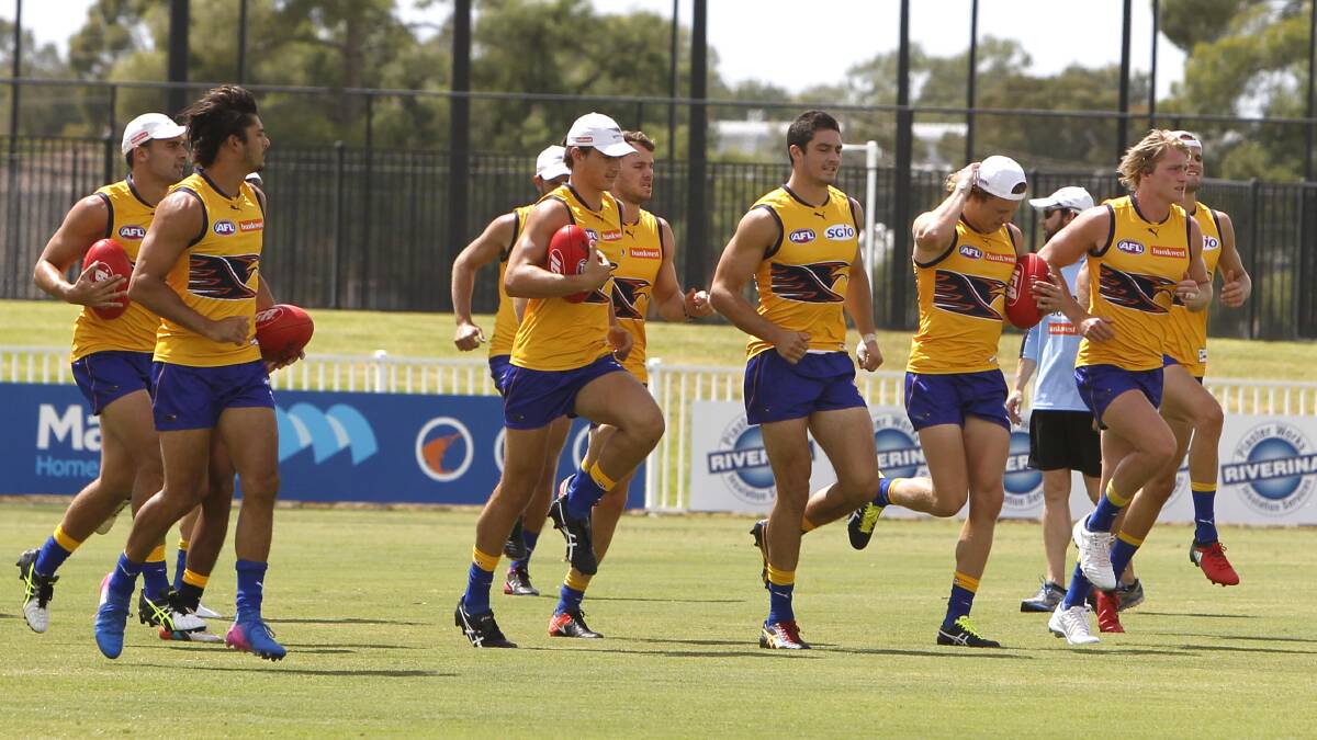 HAPPY TO BE HERE: West Coast players go through their paces at the club's open training session at Robertson Oval in Wagga on Friday. Picture: Les Smith