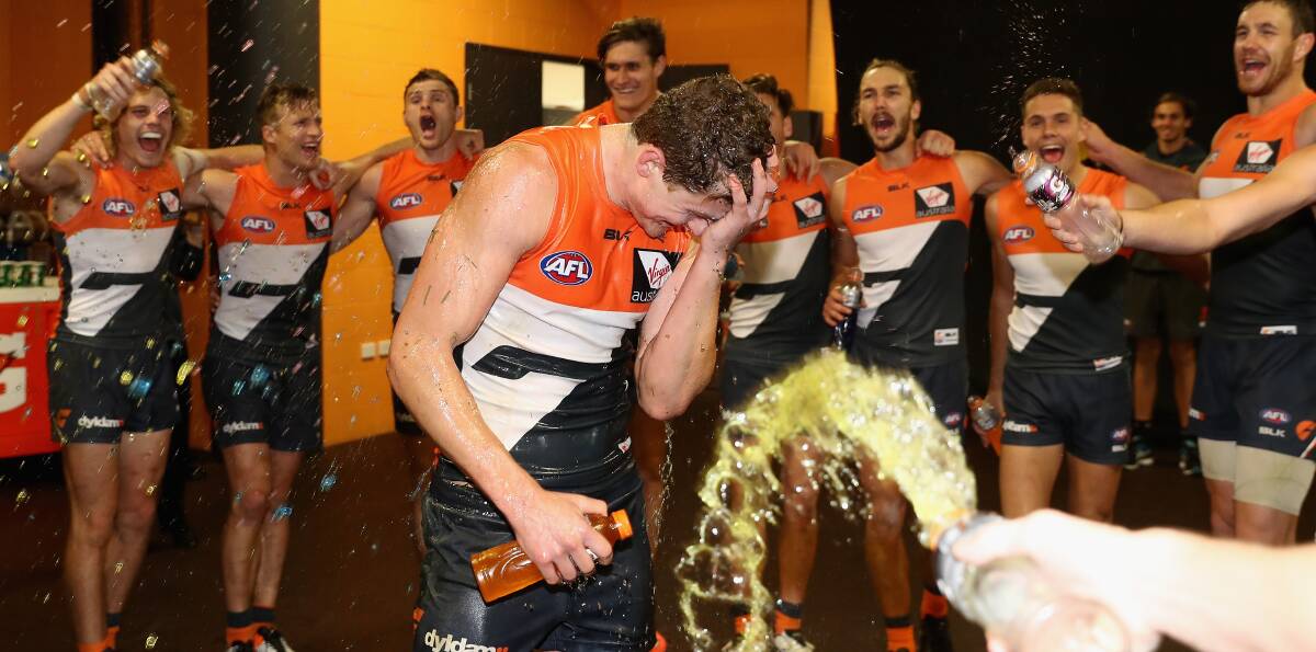 SPECIAL MOMENT: Leeton footballer Jacob Hopper is drenched in Gatorade after the Giants' win on Saturday. Picture: Getty Images