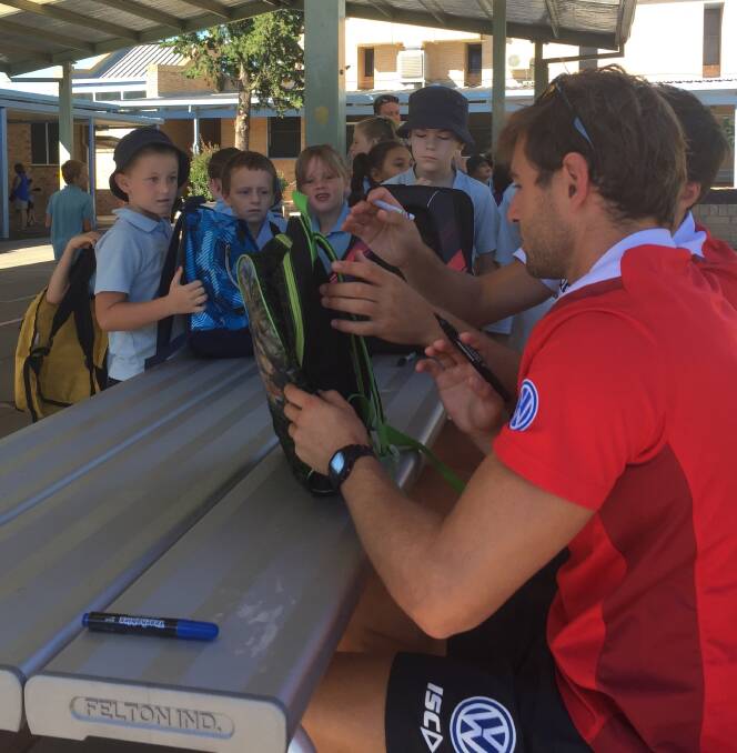 OVER THE MOON: Students at Ashmont Public School line up to get an autograph from Nick Smith and Lewis Melican on Tuesday. Picture: Matt Malone