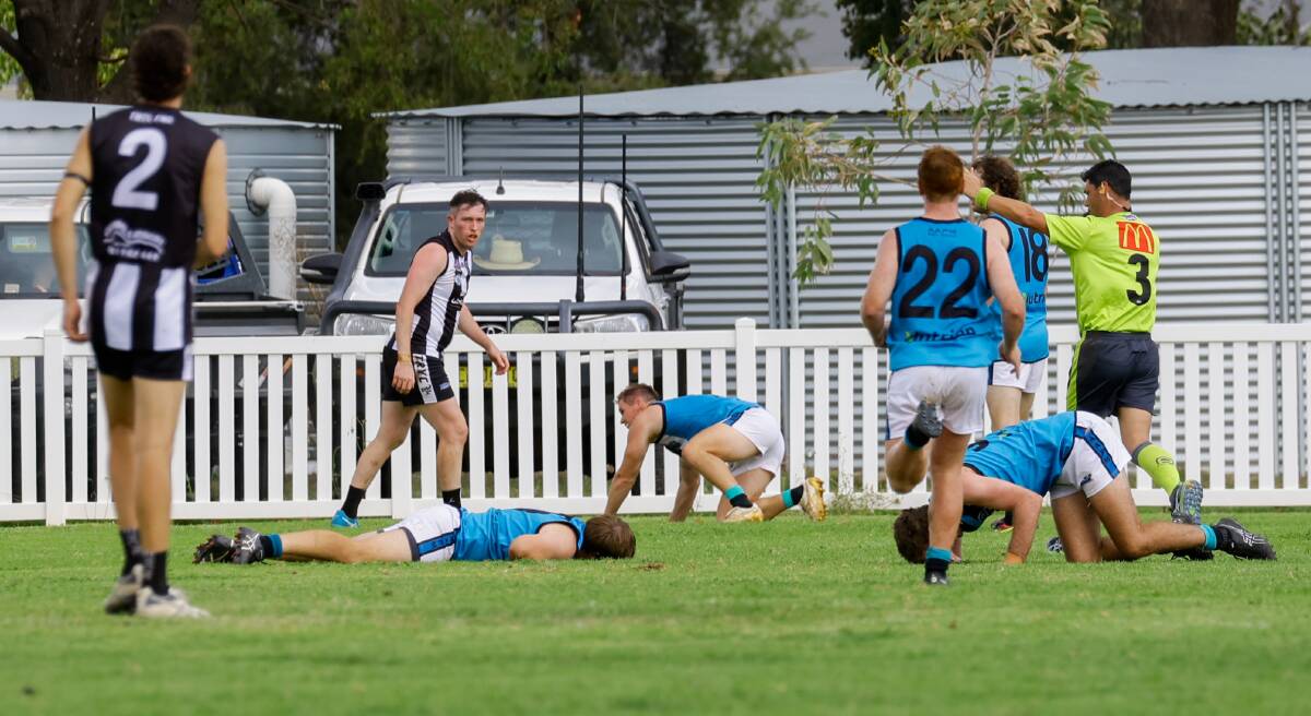Northern Jets assistant coach Sam Fisher (left) laid motionless for some time last Saturday after a head clash with a teammate when playing The Rock-Yerong Creek at Victoria Park. Picture by Bernard Humphreys