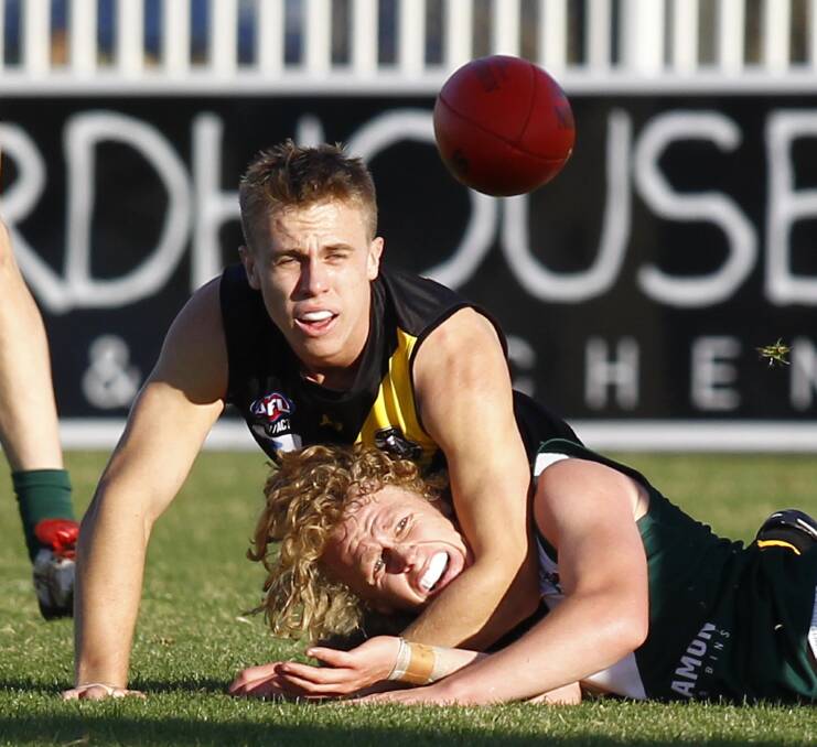 EYE ON THE BALL: Wagga Tigers' Nick McCormack and Coolamon's Luke Redfern contest for the ball at Robertson Oval on Saturday. Picture: Les Smith