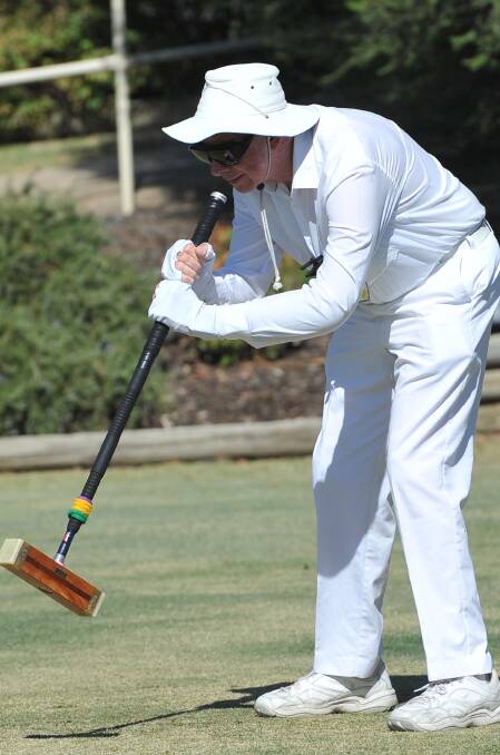 IN ACTION: John Grattan takes his shot during the four-day golf croquet carnival at Wagga Croquet Club on Saturday. Picture: Laura Hardwick