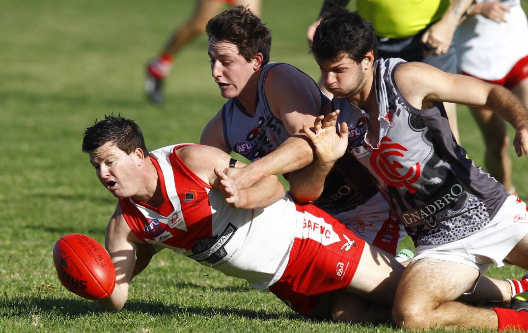 UNDER THE PUMP: Griffith's Mick Duncan beats Collingullie-Glenfield Park's Tom Keogh and Nick Perryman to the ball in Saturday's Riverina League game at Crossroads Oval. Picture: Les Smith