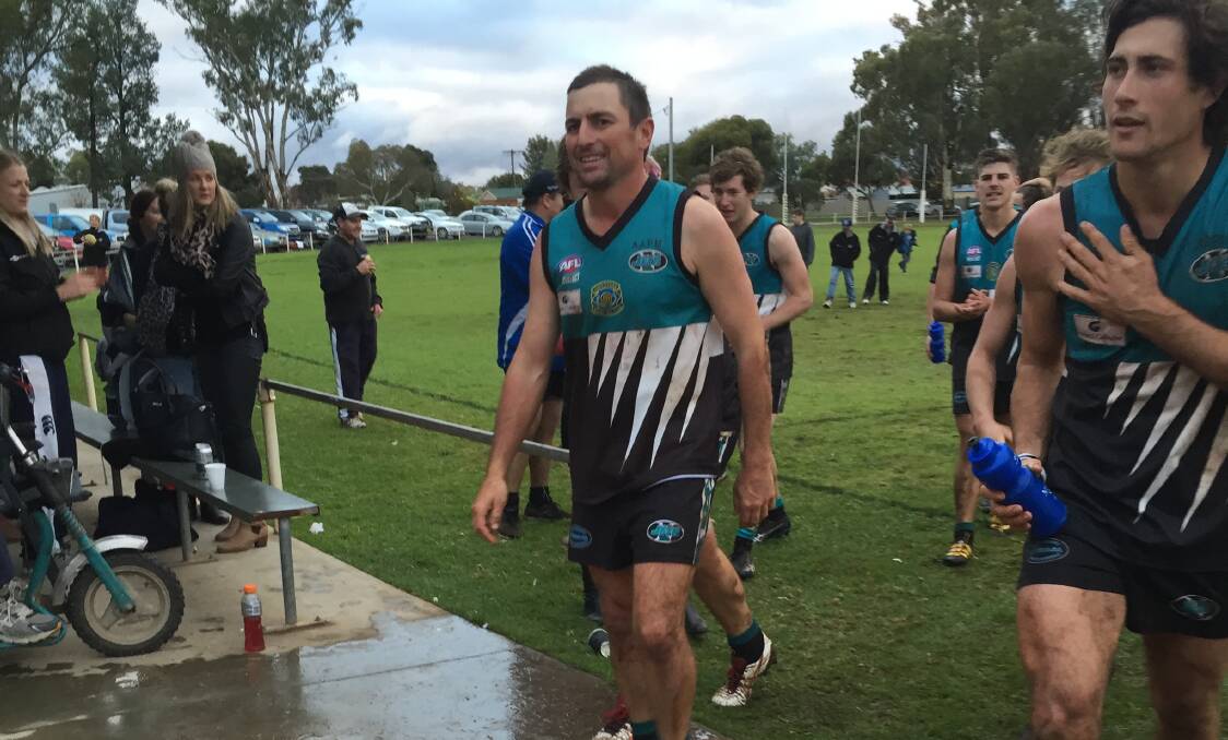 ALL SMILES: Northern Jets' veteran Ben Prentice leads his team off the field following a win in his 300th first grade game at Ariah Park on Saturday. 