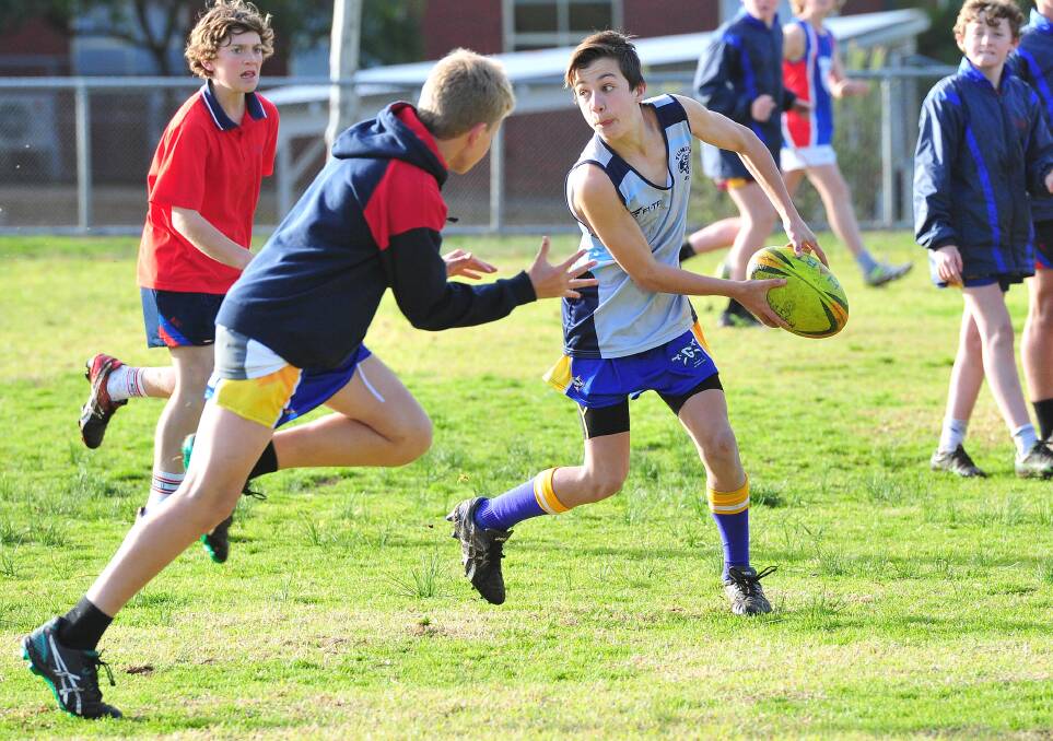 PRACTICE MAKES PERFECT: Kildare's Liam Fitzsimmons looks to get the ball out wide to teammates at the under 13 rugby league team's training session.