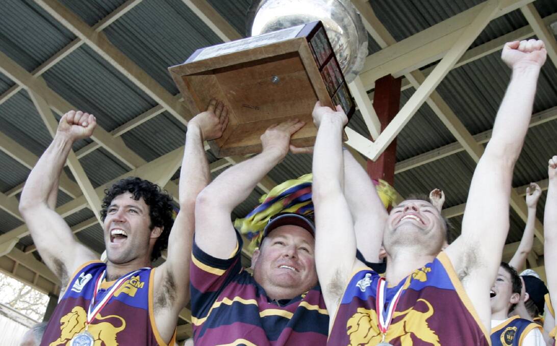 ONE OF A KIND: The late Peter McCaig (middle) lifting the 2008 premiership cup with Christen McPherson and Daniel Rankin at Narrandera. 