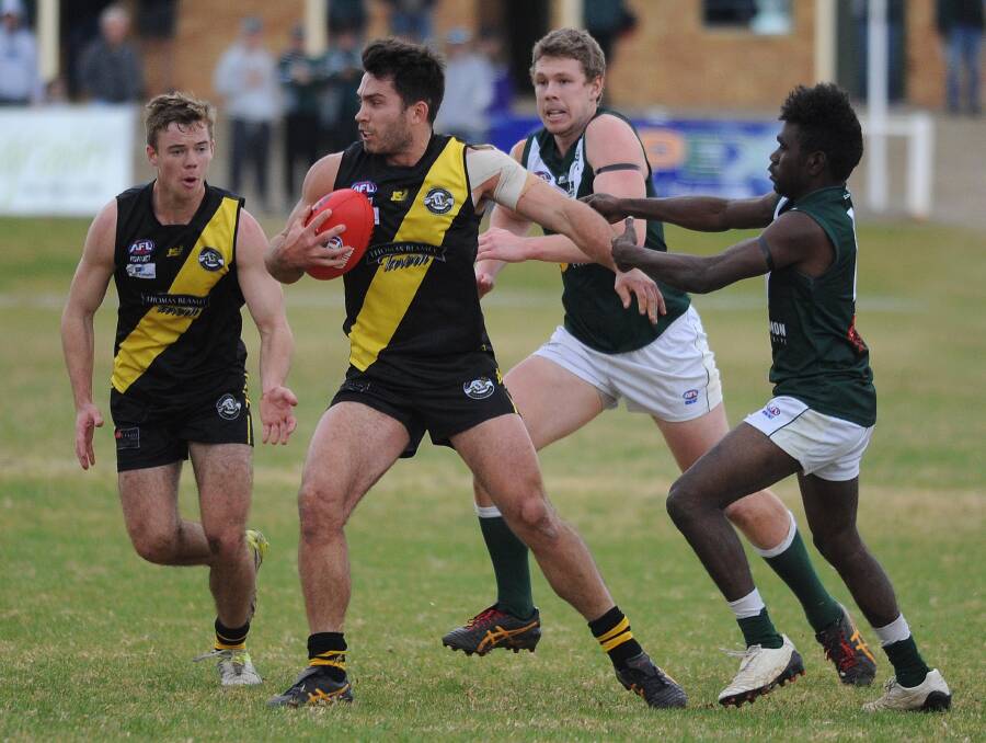 STRONG: Wagga Tigers' Jackson Kew tries to get away from Coolamon's Jack Munkara at Kindra Park on Sunday. Picture: Laura Hardwick