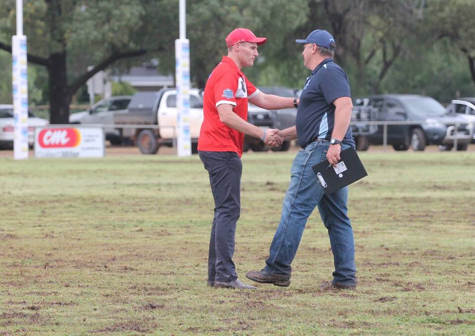 Charles Sturt University co-coach Travis Cohalan and Barellan coach Peter Green shake hands at game's end on Saturday. Picture by Pigs and Sows 2024 Photos