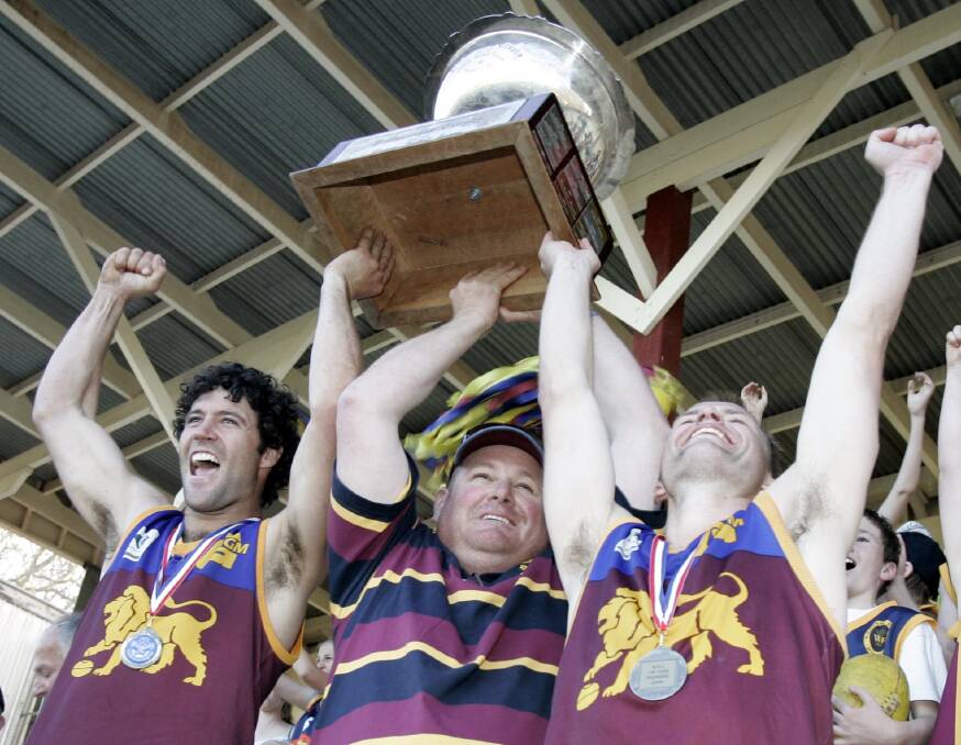 DEARLY MISSED: The late Peter McCaig (middle) lifts the 2008 Riverina League premiership cup with co-coaches Christen McPherson and Daniel Rankin.