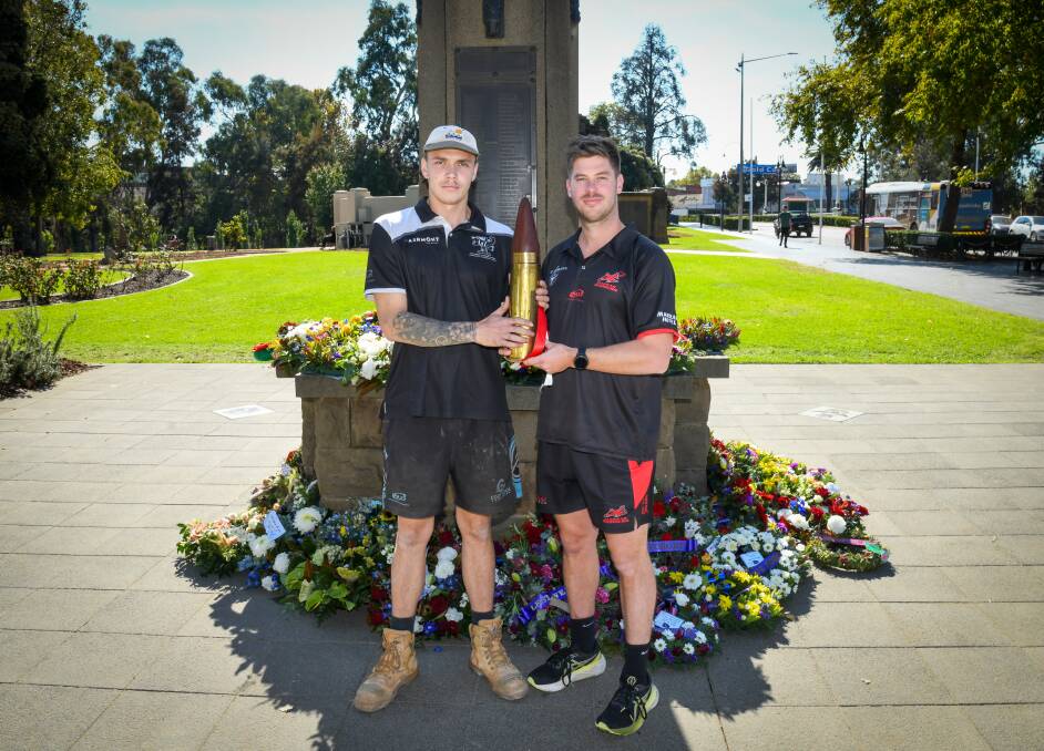 The Rock-Yerong Creek vice-captain Will Adams and Marrar coach Cal Gardner with the shell that be will played for in Saturday's ANZAC Challenge at Langtry Oval. Picture by Bernard Humphreys