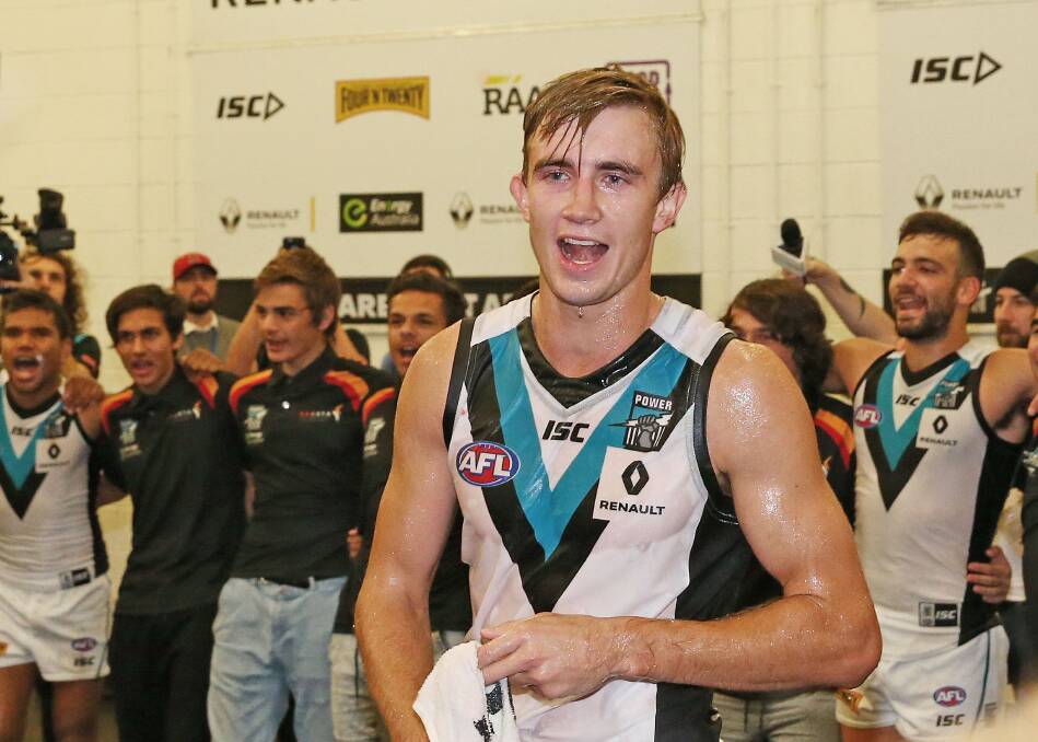 MAGIC MOMENT: Wagga's Dougal Howard is drenched in sports drinks as he sings the Port Adelaide song for the first time on Saturday night.