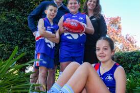 Terry and Bec Daniher show off the new Big Freeze socks to Turvey Park juniors Billy, Judd and Mia McKelvie. Picture by Bernard Humphreys