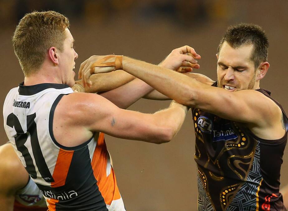 ON THE COMEBACK: Greater Western Sydney's Jacob Townsend (left) niggles with Hawthorn captain Luke Hodge in the game against the Hawks last year.